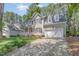 Inviting two-story home with a covered porch, attached garage, and beautifully landscaped front yard at 9308 Carisbrook Ct, Raleigh, NC 27615