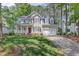 Traditional two-story home with a well-manicured lawn, red door, and white trim at 9308 Carisbrook Ct, Raleigh, NC 27615
