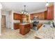 Eat-in kitchen with stainless steel appliances, an island, and granite countertops at 9308 Carisbrook Ct, Raleigh, NC 27615