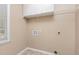 Functional laundry room with overhead cabinets and shelving for ample storage solutions at 9308 Carisbrook Ct, Raleigh, NC 27615