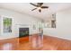 Bright living room with a fireplace, hardwood floors, and access to the backyard at 9308 Carisbrook Ct, Raleigh, NC 27615