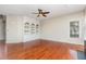 Spacious living room with hardwood floors and custom built-in shelving at 9308 Carisbrook Ct, Raleigh, NC 27615