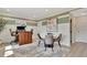 Open dining area features a modern table set, adjacent office space, and hardwood flooring at 10011 Secluded Gdn Dr # 169, Apex, NC 27523