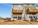 Back exterior showcasing the two-story home with a second-story wooden deck and sliding glass doors at 10011 Secluded Gdn Dr # 169, Apex, NC 27523