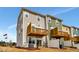 Exterior rear view featuring two-story construction, wooden decks on second floor, and outdoor seating at 10011 Secluded Gdn Dr # 169, Apex, NC 27523