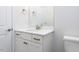 Bathroom vanity featuring a white cabinet, white countertops and a framed mirror at 1011 Coldspring Circle, Durham, NC 27705