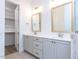 Bathroom featuring double vanity, framed mirrors, and walk-in closet at 1011 Coldspring Circle, Durham, NC 27705