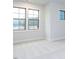 Bedroom with neutral walls, plush carpeting, and large windows at 1011 Coldspring Circle, Durham, NC 27705