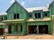 New construction home in progress features Zip System sheathing, framed openings for windows and garage at 1011 Coldspring Circle, Durham, NC 27705