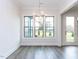 Bright dining room featuring hardwood floors, contemporary chandelier, and large windows at 1011 Coldspring Circle, Durham, NC 27705