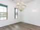 Dining room with natural light from the windows, white walls, and a decorative chandelier at 1011 Coldspring Circle, Durham, NC 27705