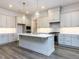 Gourmet kitchen featuring an island, custom cabinets, stainless steel appliances, and quartz countertops at 1011 Coldspring Circle, Durham, NC 27705