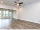 Bright living room with luxury vinyl floors, ceiling fan, and multiple windows at 1011 Coldspring Circle, Durham, NC 27705