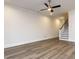 Spacious living room area with luxury vinyl floors, ceiling fan, staircase, and neutral colors at 1011 Coldspring Circle, Durham, NC 27705