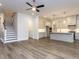 Open floorplan featuring stairs, a kitchen with an island, and luxury vinyl floors at 1011 Coldspring Circle, Durham, NC 27705