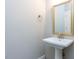 Stylish powder room with a pedestal sink and framed mirror at 1011 Coldspring Circle, Durham, NC 27705