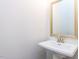 Powder room featuring pedestal sink and framed mirror at 1011 Coldspring Circle, Durham, NC 27705