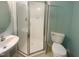 Bathroom featuring a glass enclosed shower, tile flooring, white toilet, and pedestal sink at 102 Darley Dale Loop, Apex, NC 27502