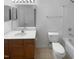 Bathroom featuring a mirror, updated vanity, white toilet, and shower and tub combo at 102 Darley Dale Loop, Apex, NC 27502