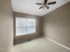 Bedroom featuring a ceiling fan, large window, and wall to wall carpet at 102 Darley Dale Loop, Apex, NC 27502