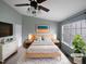 Beautiful bedroom featuring a ceiling fan, large window, and coordinated furniture set at 102 Darley Dale Loop, Apex, NC 27502