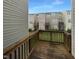 View from the wooden deck overlooking the backyard and neighboring townhomes with sunny blue skies above at 102 Darley Dale Loop, Apex, NC 27502