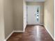 Welcoming entryway with hardwood floors, a front door with glass panels, and neutral wall colors at 102 Darley Dale Loop, Apex, NC 27502
