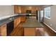 Well-equipped kitchen boasts stainless steel appliances, wooden cabinets, and a central island at 102 Darley Dale Loop, Apex, NC 27502