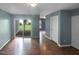 Spacious living room with sliding doors to the backyard, laminate flooring, and neutral paint at 102 Darley Dale Loop, Apex, NC 27502