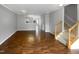 Open concept living room featuring hardwood floors, grey walls, staircase, and lots of natural light at 102 Darley Dale Loop, Apex, NC 27502