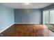 Bright living room with laminate floors and sliding glass doors, providing access to the outdoor space at 102 Darley Dale Loop, Apex, NC 27502