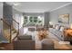 Bright and spacious living room featuring neutral paint, hardwood floors, and lots of natural light at 102 Darley Dale Loop, Apex, NC 27502
