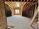 Attic space featuring wooden framework, a window, and ample room for storage or conversion at 1027 Coldspring Circle, Durham, NC 27705