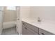 Neutral bathroom with grey vanity, white countertop, and marble tile shower at 1027 Coldspring Circle, Durham, NC 27705