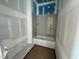 Unfinished bathroom features a new tub with tiled wall, ready for your personal touch and design at 1027 Coldspring Circle, Durham, NC 27705