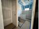 Unfinished bathroom featuring blue taped walls and a window ready for design and customization at 1027 Coldspring Circle, Durham, NC 27705