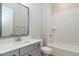 Bathroom with a tub-shower, single sink vanity, and modern fixtures at 1027 Coldspring Circle, Durham, NC 27705