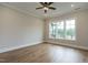 Bedroom featuring hardwood floors, a ceiling fan, and a large window at 1027 Coldspring Circle, Durham, NC 27705