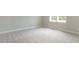 Neutral bedroom featuring carpet and double windows at 1027 Coldspring Circle, Durham, NC 27705
