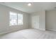 Light-filled bedroom with neutral carpet, closet, and bright double window at 1027 Coldspring Circle, Durham, NC 27705