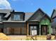 Modern two-story home with a two-car garage and a welcoming front porch is under construction at 1027 Coldspring Circle, Durham, NC 27705