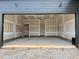 Garage with drywall, concrete floors, two doors, and plenty of space for parking and storage at 1027 Coldspring Circle, Durham, NC 27705