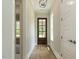 Light-filled hallway with hardwood floors and modern light fixture at 1027 Coldspring Circle, Durham, NC 27705