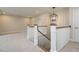 Hallway featuring a staircase, neutral carpet, and modern lighting at 1027 Coldspring Circle, Durham, NC 27705