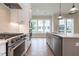 Well-lit kitchen with stainless steel appliances, white cabinets, and island at 1027 Coldspring Circle, Durham, NC 27705