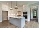 Bright kitchen with white cabinets, gray island, and stainless steel appliances at 1027 Coldspring Circle, Durham, NC 27705