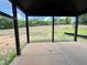 Covered outdoor patio with a view of a green lawn and trees, perfect for enjoying the outdoors at 1027 Coldspring Circle, Durham, NC 27705