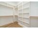 Spacious walk-in closet with custom shelving and wood floors at 1027 Coldspring Circle, Durham, NC 27705
