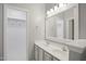 Bathroom features a double vanity, a large mirror, and an open doorway to the closet at 106 Gumdrop Path, Apex, NC 27502
