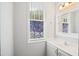Bathroom featuring a vanity with a sink, a large mirror, and a vibrant patterned window at 106 Gumdrop Path, Apex, NC 27502